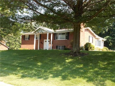 Exterior Front. Large trees provide the front yard