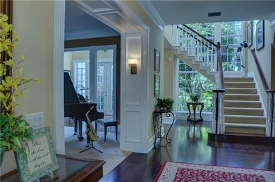 One of TWO staircases, formal living to the left, so much light.