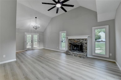 Unfurnished living room featuring ceiling fan with