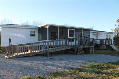 Back view the home and of screened in Back Porch