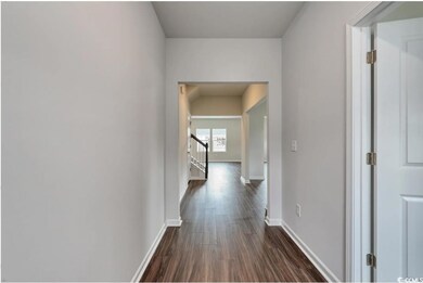 Corridor featuring dark hardwood / wood-style floo