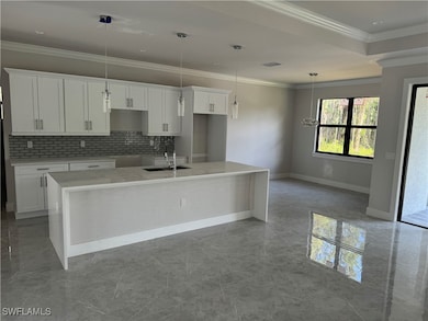 Kitchen with decorative backsplash, white cabinetr