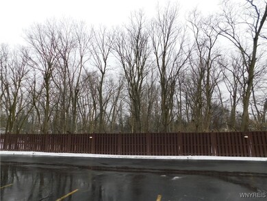 View of parking and vacant land beyond
