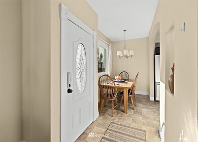 Elegant stain glass entry door that is sure to be noticed by guest.  The dining space that is open to the kitchen provides a great place to relax and keep the cook company!
