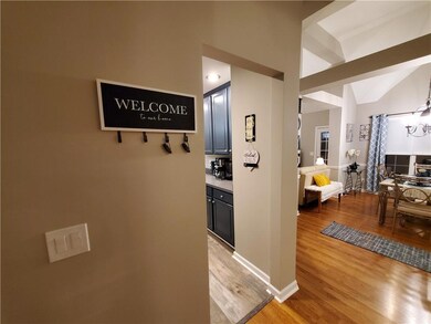 Hall with light hardwood / wood-style flooring and