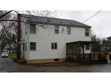 Rear view of duplex showing wood deck on one unit.