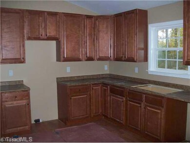 Kitchen. Great kitchen cabinets, laminate floors and vaulted ceiling with recessed lighting.