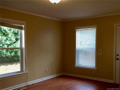 Living room with big windows, tasteful paint, and 