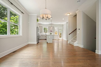 Unfurnished living room with a chandelier, stairs,