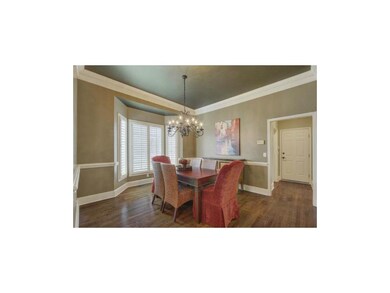 hardwood floors and bay window in formal dining.