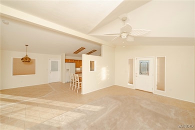 Tiled spare room with lofted ceiling with beams an