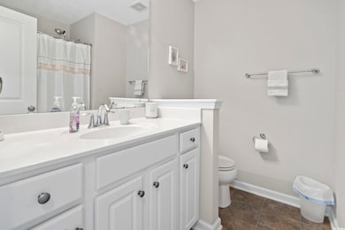 Bathroom with vanity, tile patterned flooring, toi