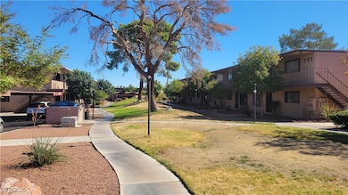 View of property's community featuring a lawn and stairway
