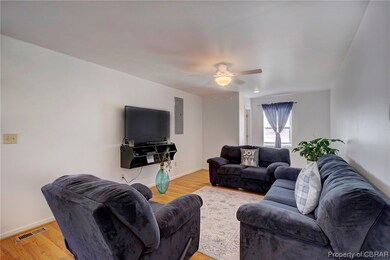 Living room featuring ceiling fan and light hardwo