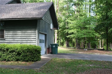 View of property exterior with a garage and roof w