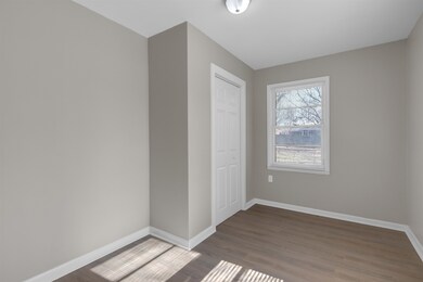 Unfurnished bedroom with wood-type flooring and a 