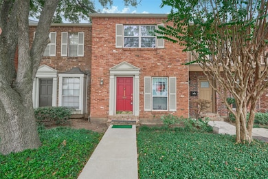 Charming two-story brick townhouse with a striking