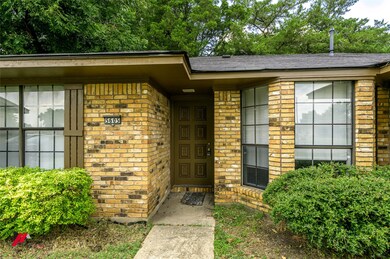 View of exterior entry with brick siding
