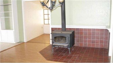 Wood burning stove in dining room area. Extra room