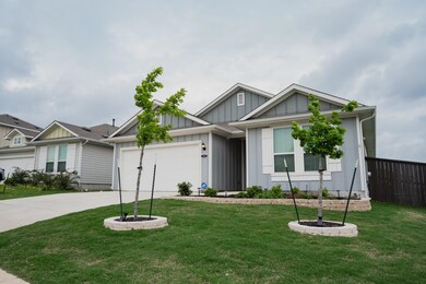 Ranch-style house featuring a garage, a front law