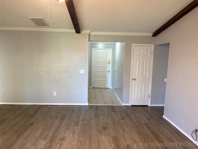Unfurnished room featuring wood finished floors, b