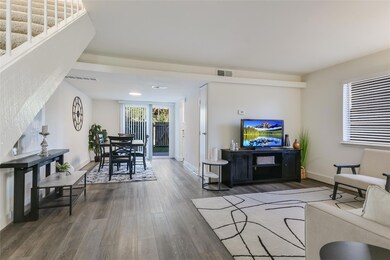 Living area with wood finished floors and baseboa
