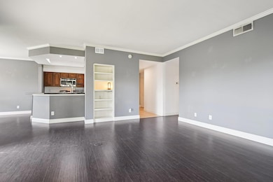 Unfurnished living room featuring crown molding, 