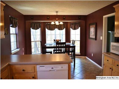 Large eat-in kitchen overlooks the private, serene