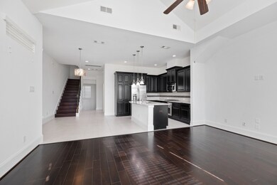 The home features open floor plan, beautiful hardw