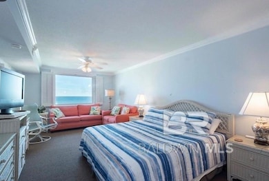 Bedroom with carpet floors, ornamental molding, and ceiling fan