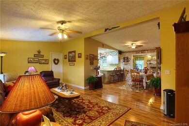 View of living room into dining area, kitchen and 