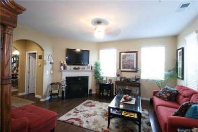 The inviting space with gas log fireplace and arch