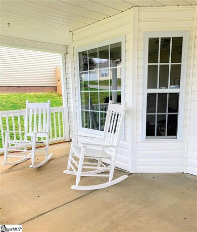 Spacious covered rocking chair front porch