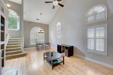 Living area with high vaulted ceiling, wood finis