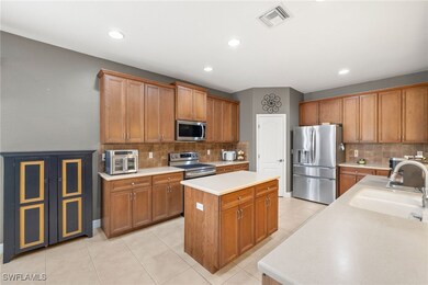 Kitchen featuring a kitchen island, backsplash, vi