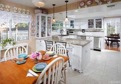 The chef in the family is going to truly appreciate the newly remodeled kitchen with its sparkling garden window,  recessed lighting, chic white beadboard cabinetry that reaches the ceiling, granite counter tops, custom tiled backsplash with decorati