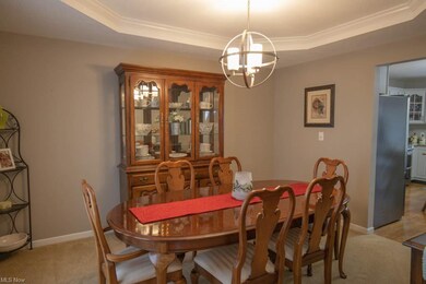 Formal dining room with a tray ceiling.
