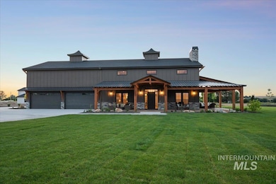 View of front of house with a front lawn, a chimney, concrete driveway, a garage, and stone siding