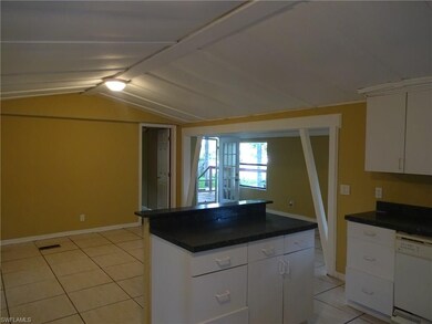 A VIEW FROM THE KITCHEN LOOKING OUT INTO THE LIVING ROOM AND DEN/FRONT ENTRY OF THE HOUSE.