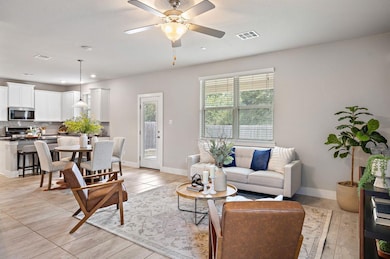 Living area featuring a ceiling fan, recessed lighting, and light tile patterned floors