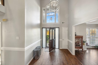 Foyer with a high ceiling, dark hardwood / wood-st