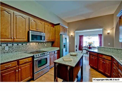 Stainless Steel appliances, granite countertops, tile backsplashes, high ceilingsm hardwood floors makes this kitchen the hub of the home.