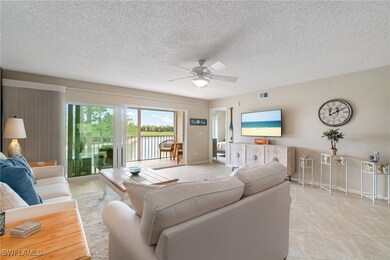 Living area with baseboards, ceiling fan, light ti