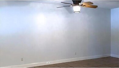 Empty room with ceiling fan and tile patterned fl
