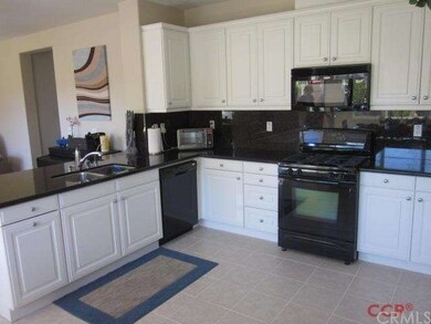 The kitchen features 12 inch floor tiles and a sla