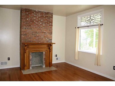 Living Room. Original Leaded glass window and bric