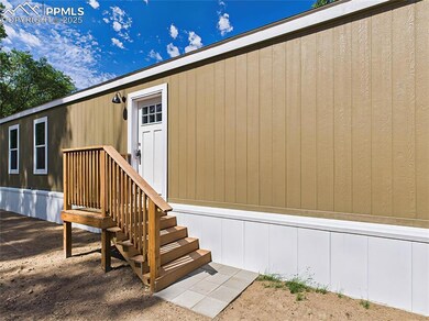 Entry with a small landing and wood steps, conveniently accessible from the driveway or yard.
