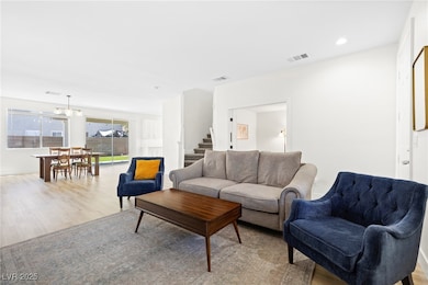 Living room with wood finished floors, stairway, a