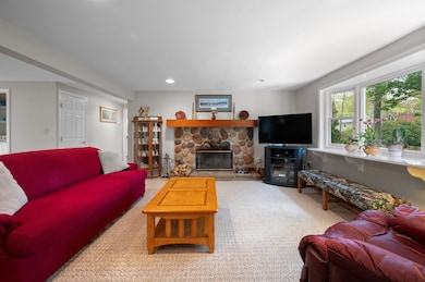 Warm up by the wood burning fireplace with a stone surround and wood mantle