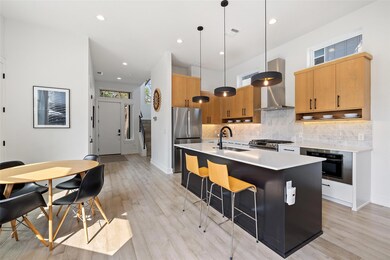 Kitchen with light countertops, stainless steel a